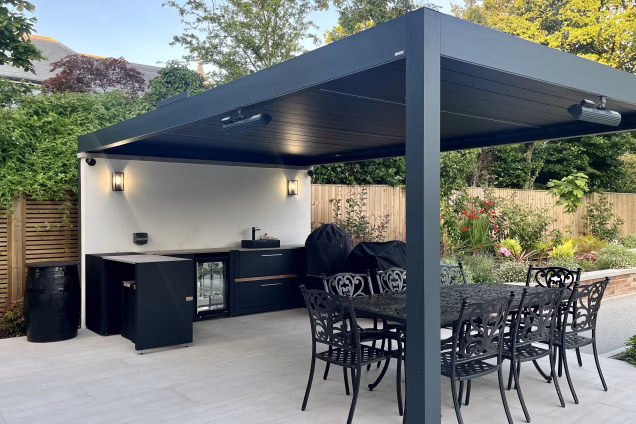 large landscaped garden with outdoor pool surrounded by patio and decking