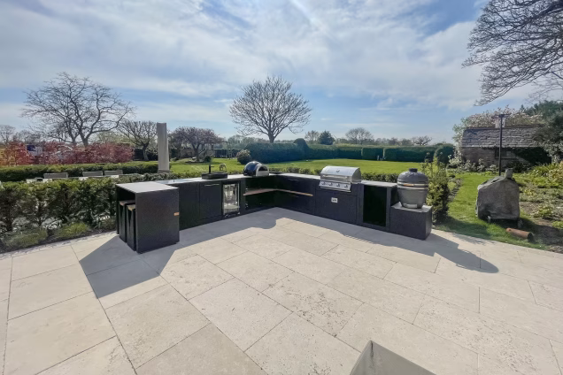outdoor kitchen on patio in large garden with pizza oven, gas bbq and charcoal bbq