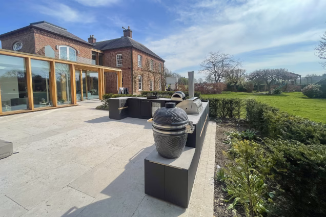 outdoor kitchen in garden of large house on patio with grillo gusto and bull gas bbq