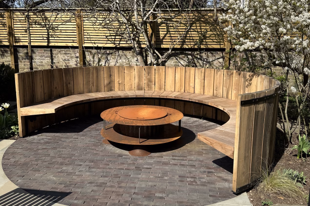 A circular bespoke seating area in a garden in Blackheath London by renowned garden designers Garden Club London