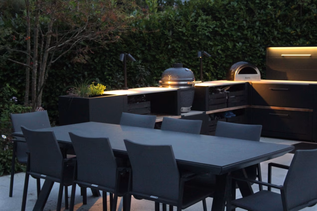 An outdoor kitchen with custom garden lighting installed in Cranleigh, Surrey, UK