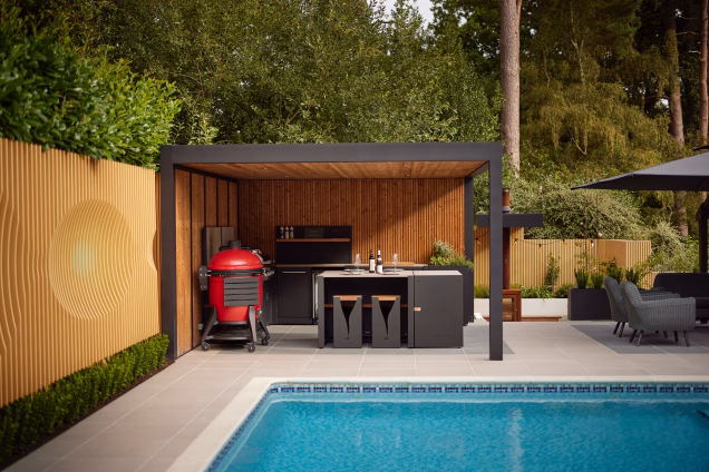 Outdoor kitchen in a garden near Ashtead, Surrey, with a forest in the background