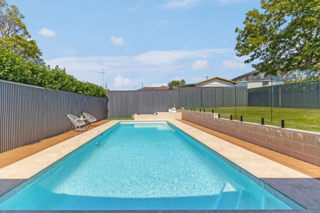 A view along the swimming pool in recently landscaped gardens at a property in Old Toongabbie, Sydney