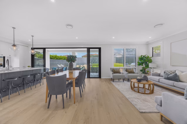 Looking through the kitchen and dining area towards the landscaped gardens and Grillo outdoor kitchen in a property in Old Toongabbie, Sydney