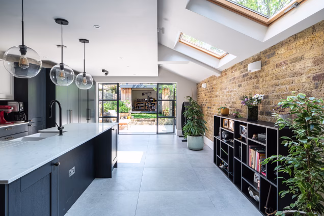 Looking through the indoor kitchen towards the Crittall-style patio doors of a house in Stoke Newington, London