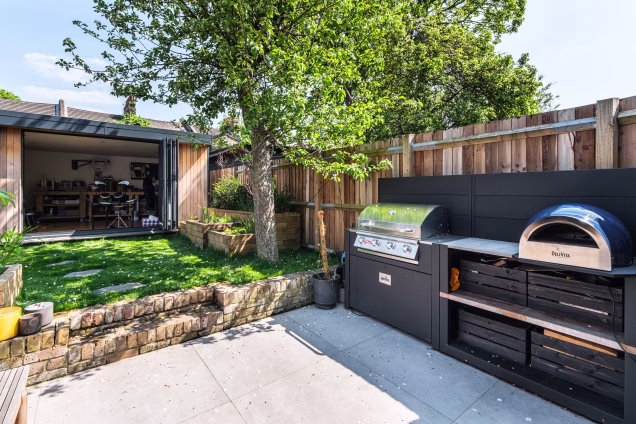 outdoor kitchen on patio in stoke Newington with gas bbq and pizza oven