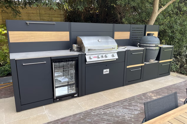 A closeup front view of a Grillo outdoor kitchen in a subtropical style garden in Richmond, London