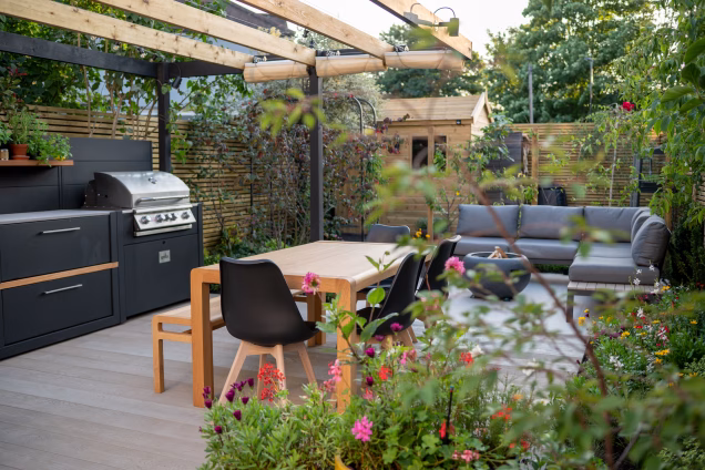 A comfy seating and dining area in a garden in Lewisham, London, by Catherine Clancy Garden Design