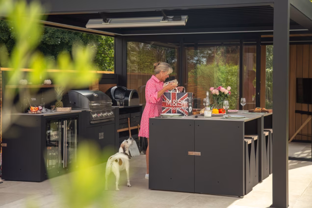 Sara working in her outdoor kitchen in Attleborough as her dog looks on