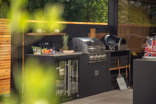 Looking through out of focus leaves into a Grillo outdoor kitchen in Attleborough