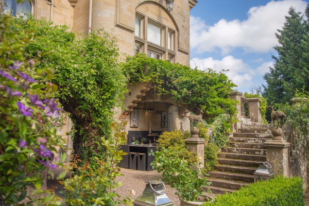 A wide angle view of an outdoor kitchen under the double perron steps of a Baronial mansion in the Scottish Borders