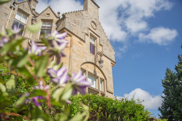 Looking up at Scottish Baronial architectural features on a large mansion in the Scottish Borders