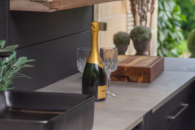 Looking along the Grillo kitchen worksurface at a bottle of Krug champagne with two cut glass wine glasses