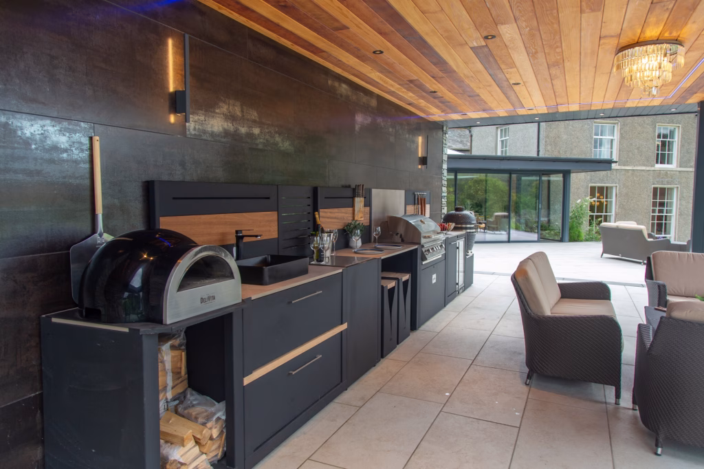 outdoor kitchen under covering at Town head Estate with bbqs, storage and seating