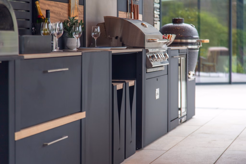 close up of grillo outdoor kitchen run with bbqs and storage