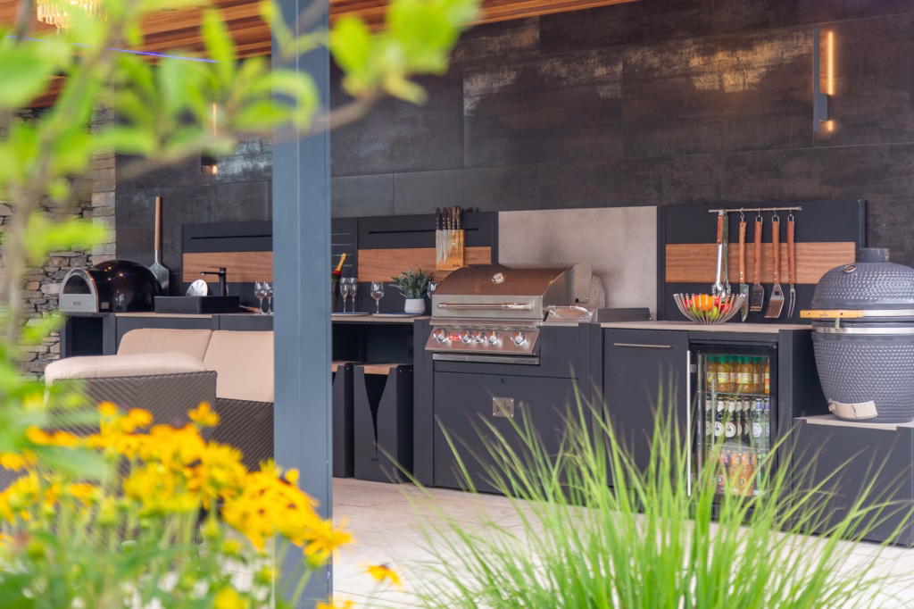 large grillo outdoor kitchen photo taken through foliage