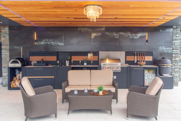 large grillo outdoor kitchen under cover with seating area in front of it