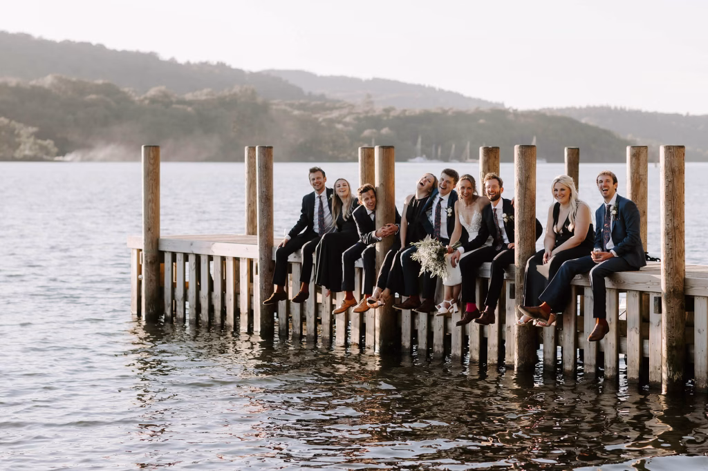 people sitting on jetty at town head estate wedding venue