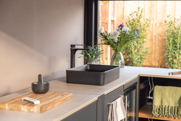 The Tarn sink in a Grillo kitchen in Acle with flowers in the background