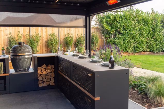 A Grillo bar table with places laid and wine glasses under a pergola in an Acle garden