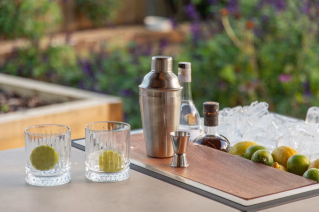 A closeup of a cocktail shaker and glasses on the Grillo Drinks Station