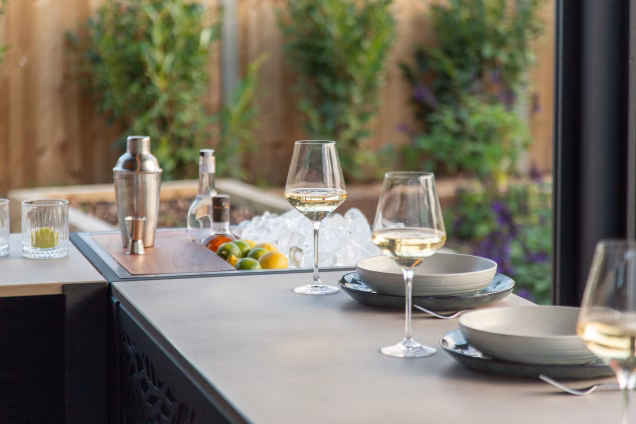 Wine glasses with champagne on a Grillo bar table in front of the Grillo Drinks Station