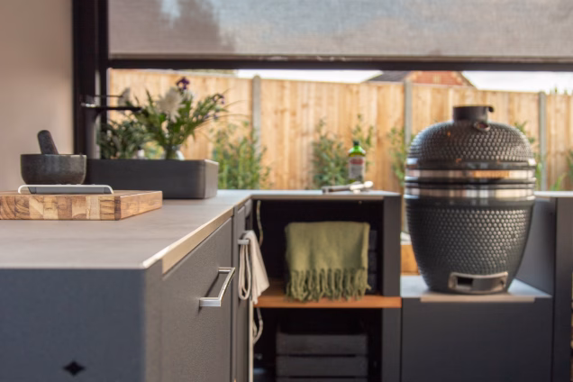A detail photo along the worksurface of a Grillo kitchen looking towards the sink and kamado BBQ