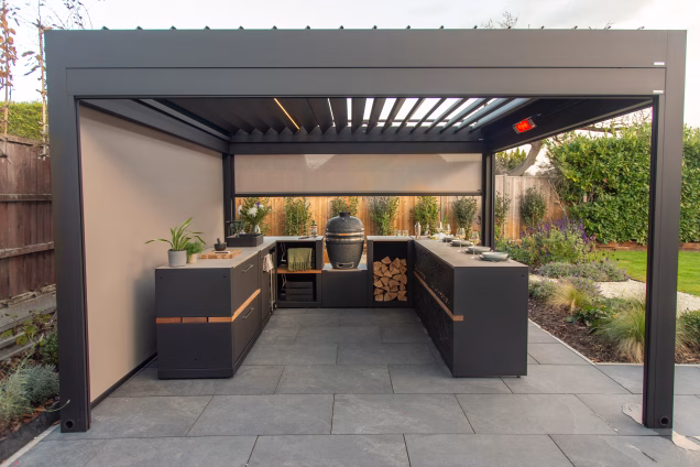 A Grillo outdoor kitchen under a Grillo Pergola with the IR heater turned on