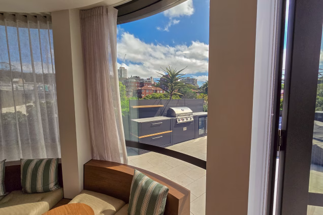 A premium penthouse office space with a view across a Sydney roof terrace featuring a Grillo kitchen