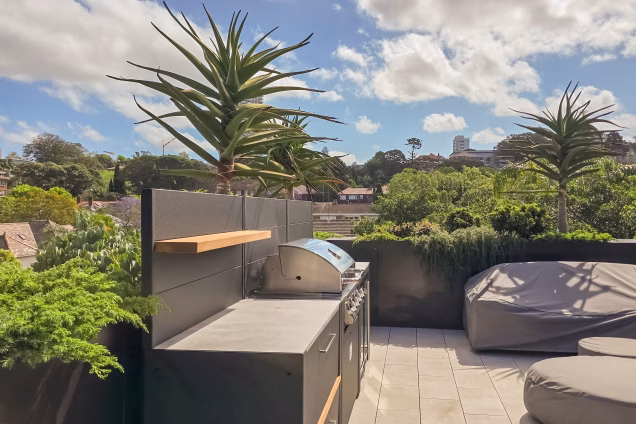 Looking along a Grillo outdoor kitchen on a Sydney roof terrace on a sunny day