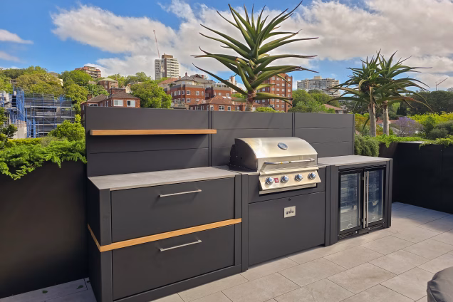A Grillo outdoor kitchen on a roof terrace in Double Bay, Sydney, with palms in the background