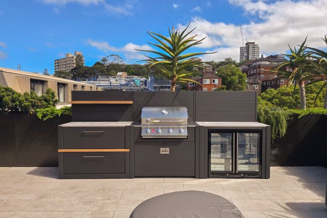 Symmetrical view of a Grillo kitchen on a Sydney roof terrace with high rise buildings in the background