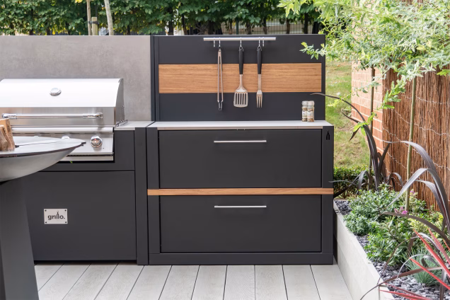 outdoor kitchen with storage unit and feature wall and bull gas grill station