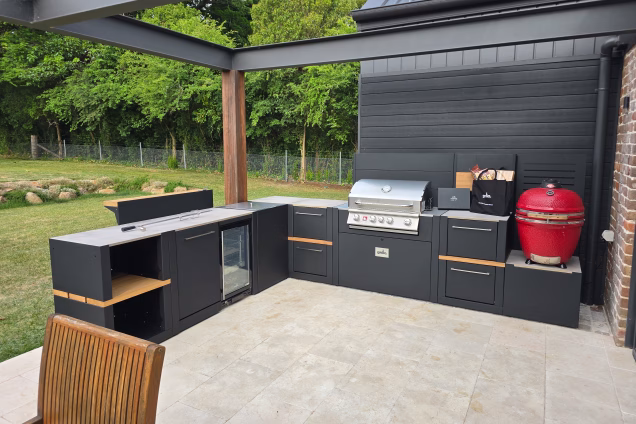 An L-shaped Grillo kitchen featuring 2 BBQs and a fridge on the patio of a house in Moss Vale