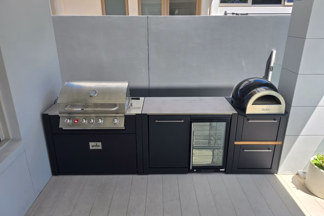 A marine-grade Grillo outdoor kitchen tightly fitting between columns in a Sydney garden