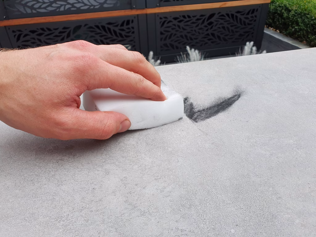 Removing a mark from the surface of a Grillo sintered stone worksurface using a magic eraser