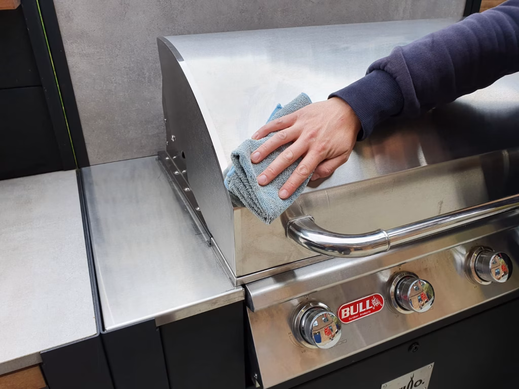 Bull Outlaw gas grill being polished with a lint-free cloth