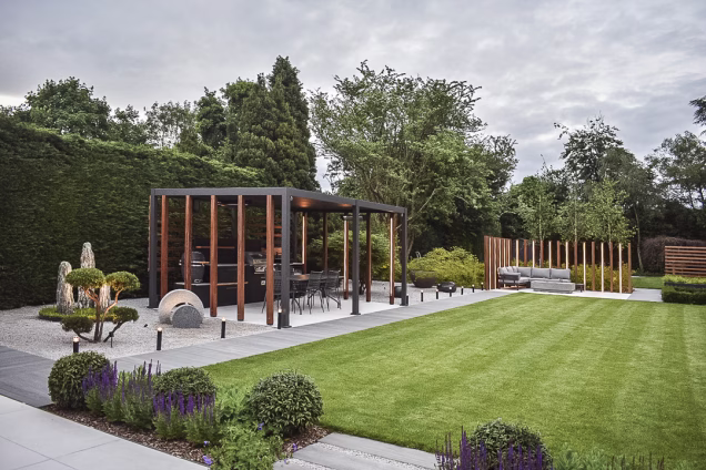 Lovely garden with patio, planting, furniture and an outdoor kitchen sheltered by a pergola