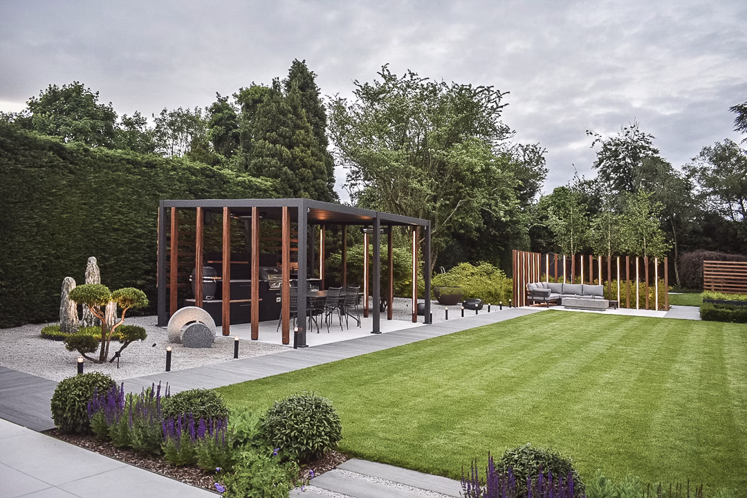 Lovely garden with patio, planting, furniture and an outdoor kitchen sheltered by a pergola