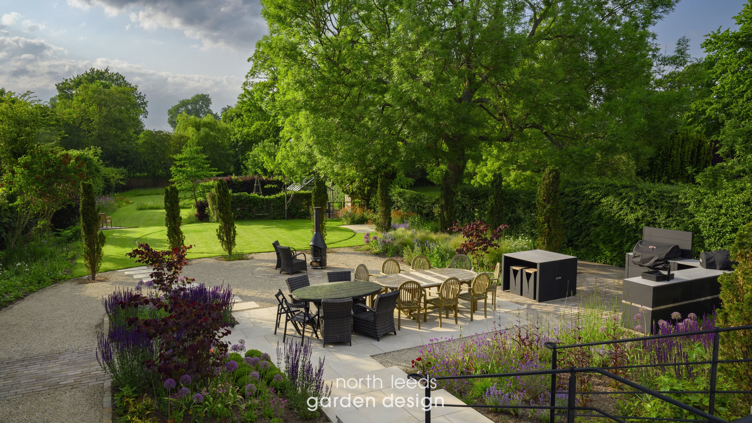 large patio and garden with seating areas, outdoor kitchen and greenhouse/kitchen garden