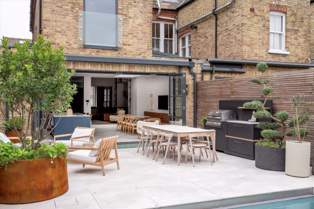 table and chairs, outdoor kitchen and seating area on patio