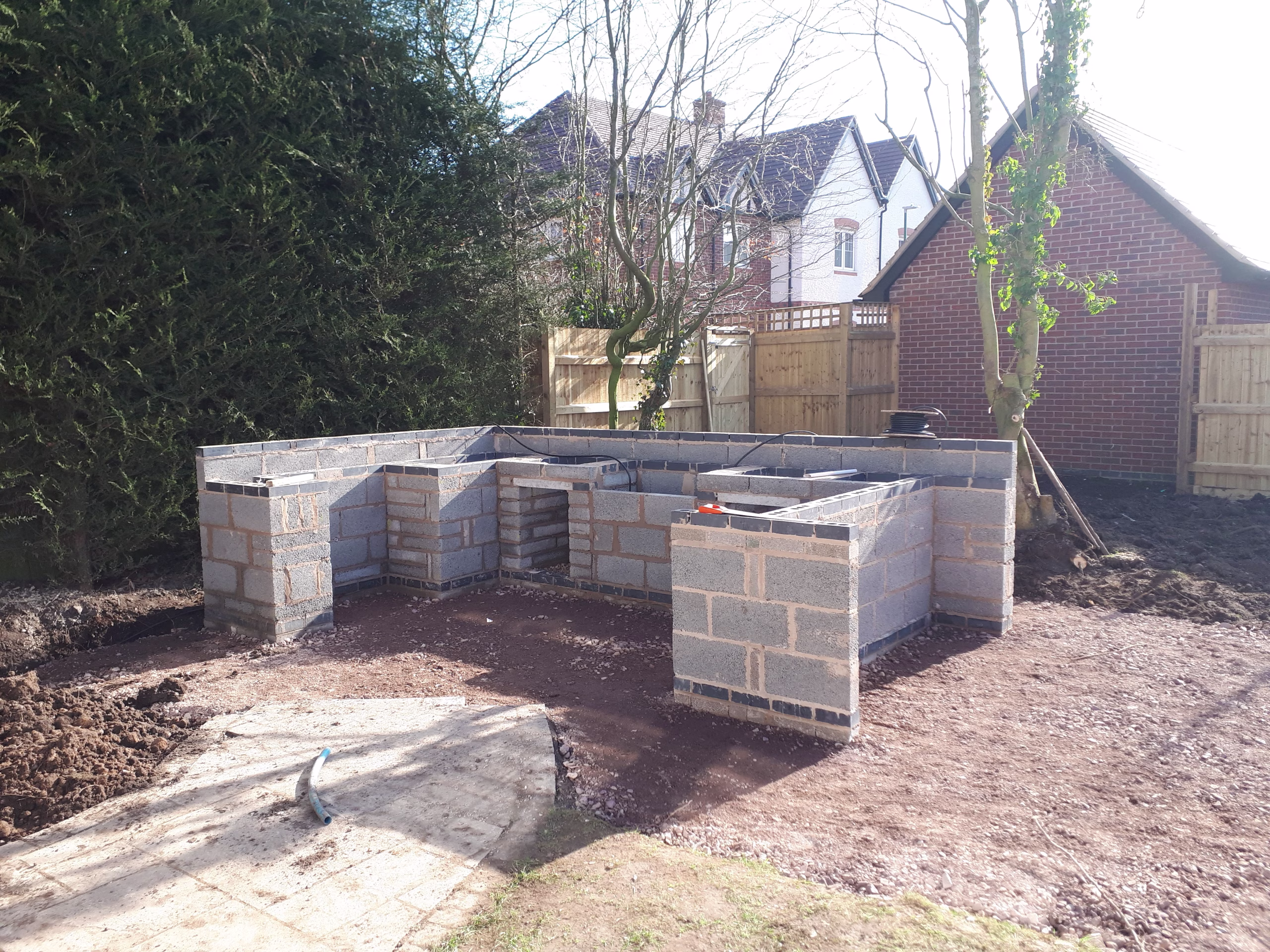 An unfinished blockwork outdoor kitchen being built