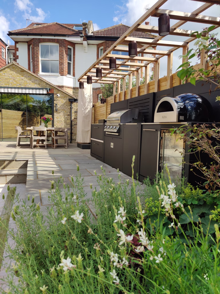 Photo of a Grillo kitchen in a sunny garden in London, with gaura and white lavender in the foreground